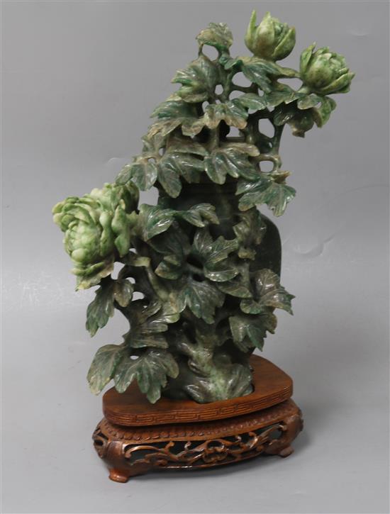 A Chinese green mottled jadeite vase and cover, 20th century, height 22cm, wood stand